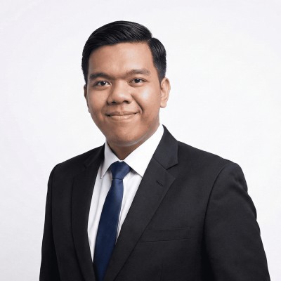 Portrait of Rizky Aditya in a dark suit and blue tie